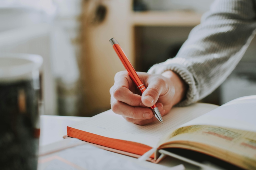 Person Holding A Pen Applying For A Student Visa