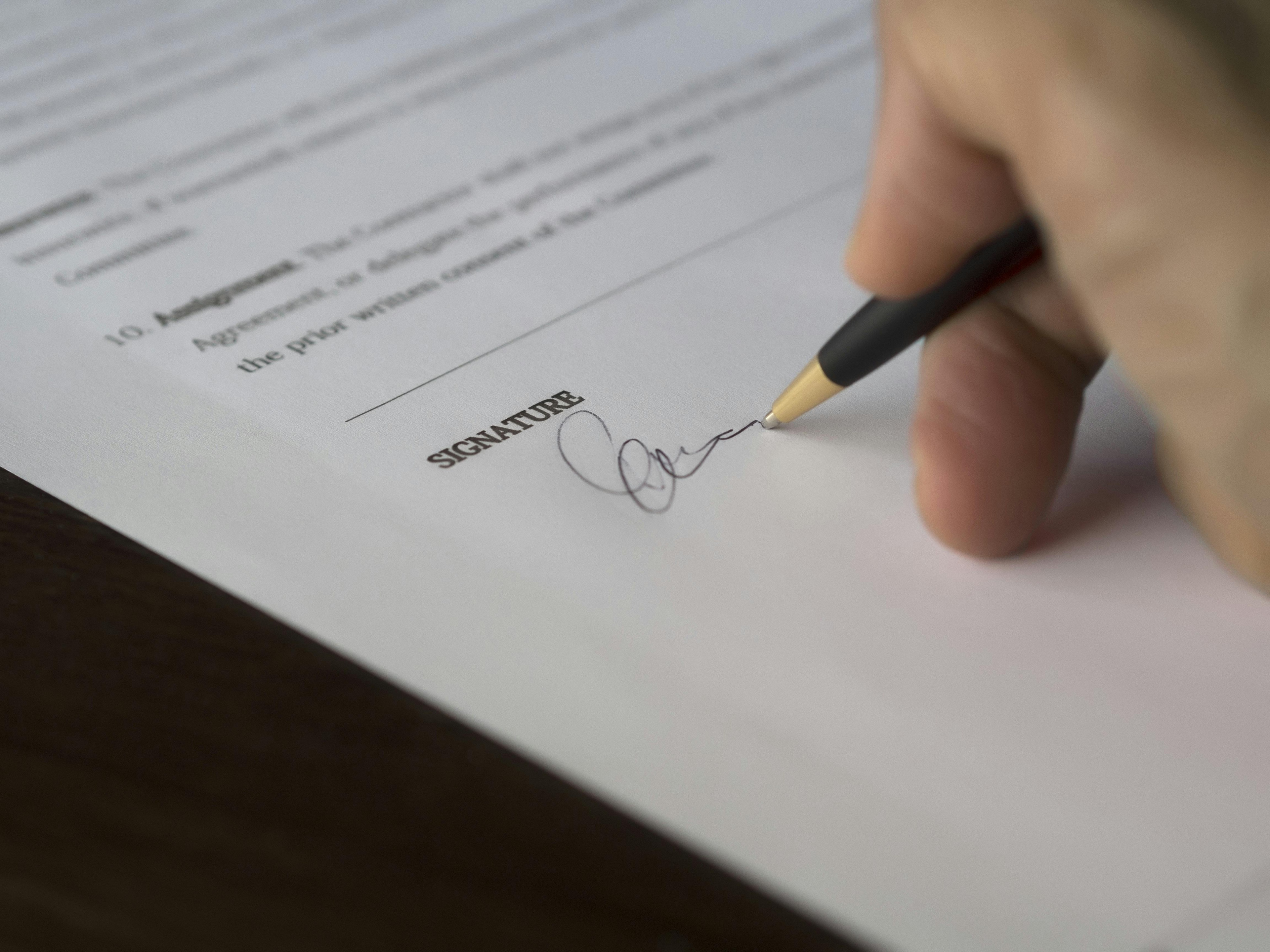Person Signing A Business Contract